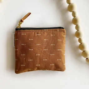 Small square pouch in rust triple dots